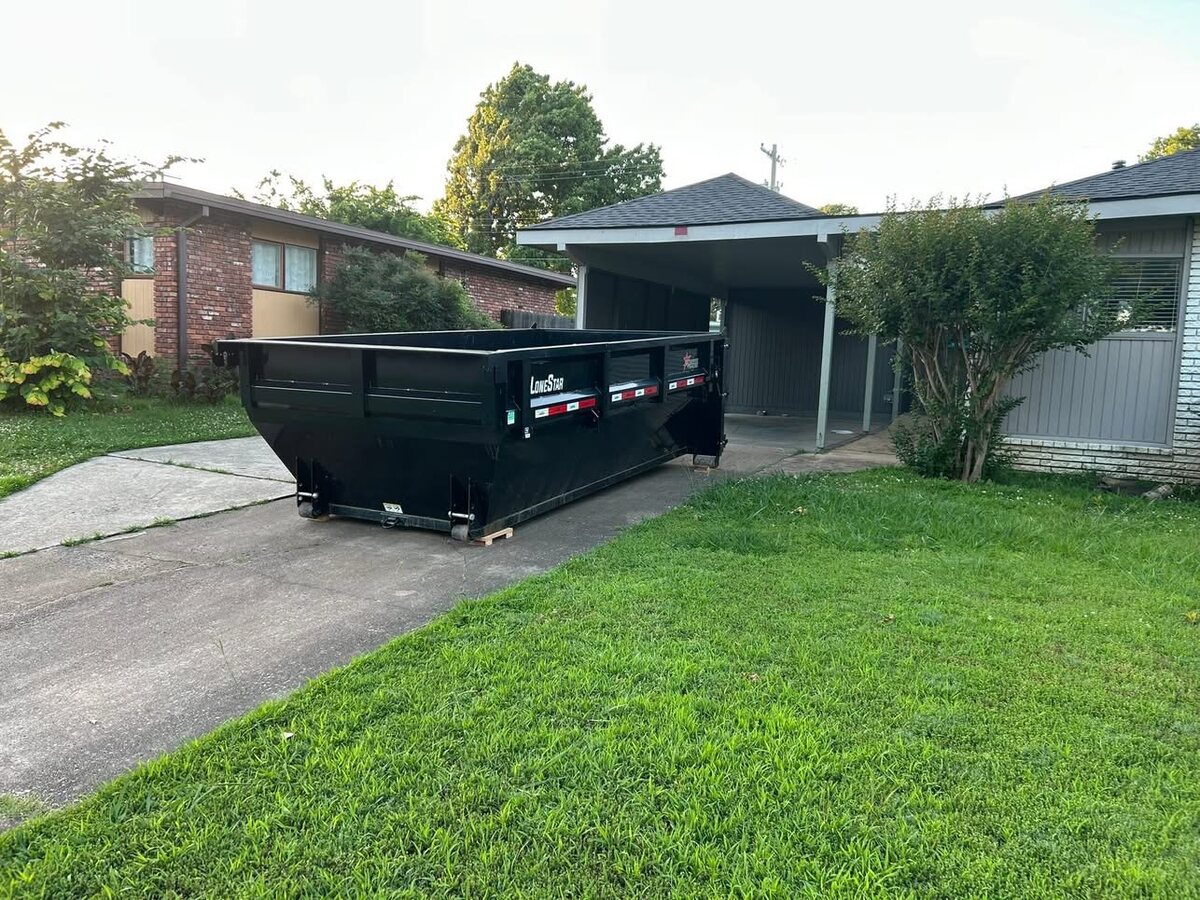 A&K Property Solutions 15-yard roll-off dumpster placed on a residential driveway in Claremore, Oklahoma
